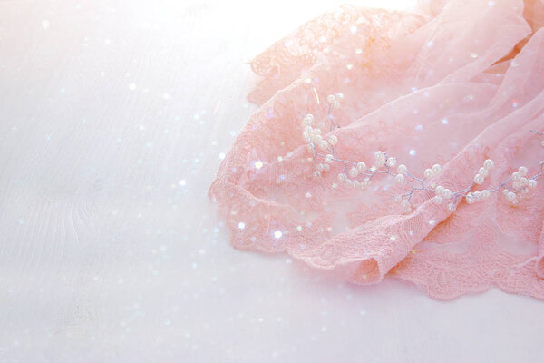 Vintage tulle pink chiffon dress on wooden white table. Wedding and girl's party concept