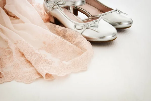 Vintage tulle pink chiffon dress and silver shoes on wooden white floor — Stock Photo, Image