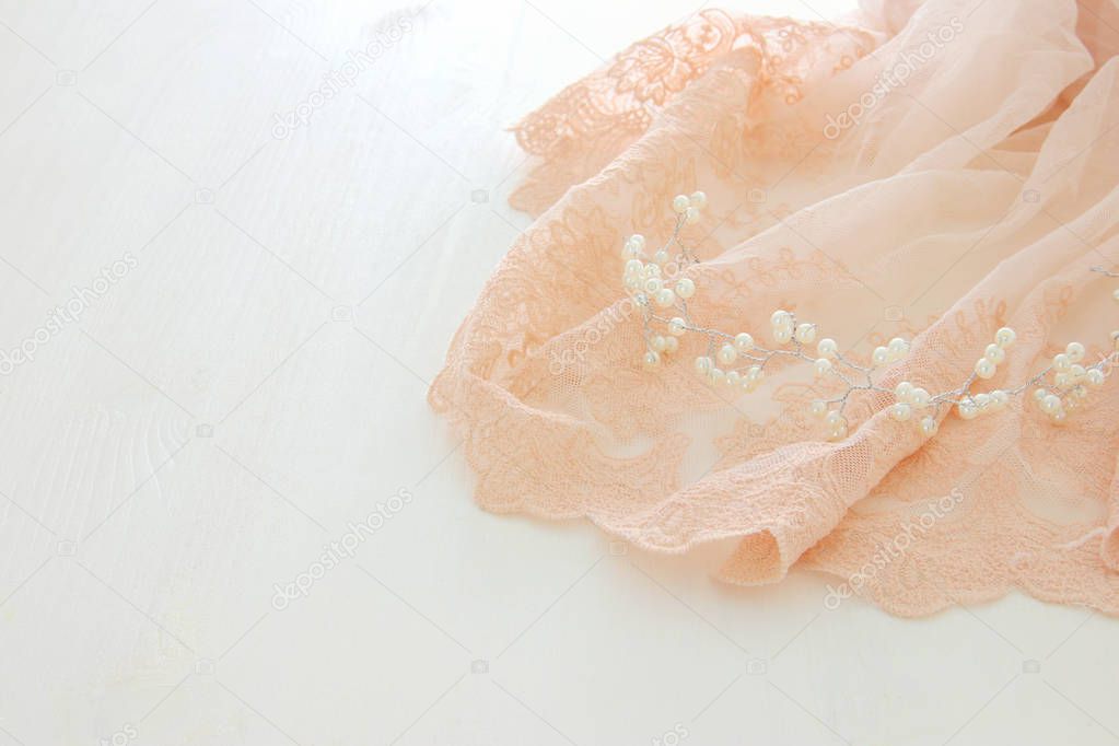 Vintage tulle pink chiffon dress on wooden white table. Wedding and girl's party concept