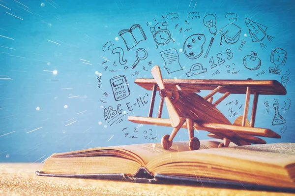 Image of toy airplane and book over wooden table with set of back to school infographics — Stock Photo, Image