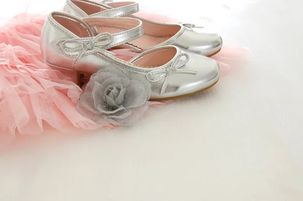 Vintage tulle pink chiffon dress and silver shoes on wooden white floor — Stock Photo, Image