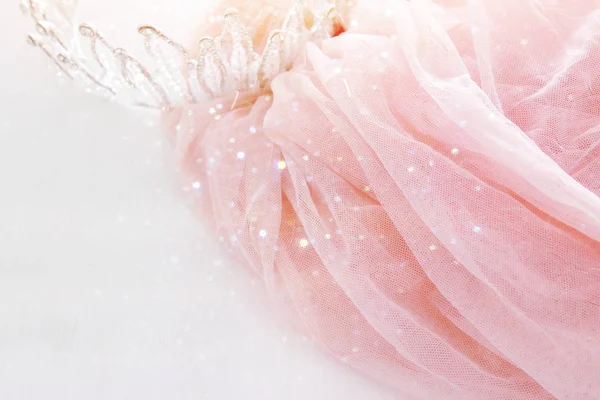 Vintage tulle pink chiffon dress and diamond tiara on wooden white table. Wedding and girl's party concept — Stock Photo, Image