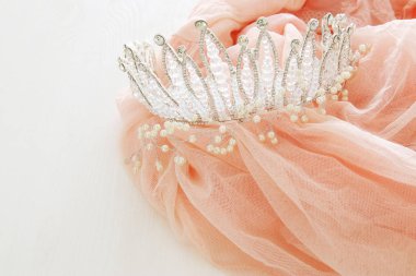 Vintage tül pembe şifon elbise ve elmas taç ahşap beyaz masa üzerinde. Düğün ve kızın parti konsept