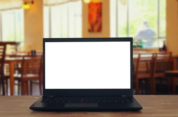 Open laptop with white screen in front of abstract blurred restaurant lights background — Stock Photo, Image