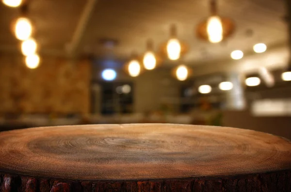 Bild eines Holztisches vor abstrakten verschwommenen Restaurant-Lichtern Hintergrund — Stockfoto