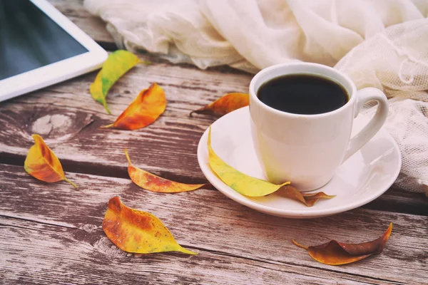 Tabletă digitală și ceașcă de cafea pe masa veche din lemn în aer liber în parc — Fotografie, imagine de stoc