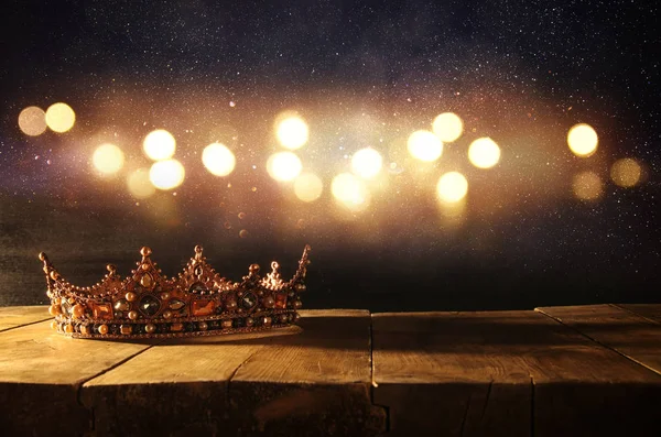 Low key of beautiful queen/king crown over wooden table. vintage filtered. fantasy medieval period — Stock Photo, Image