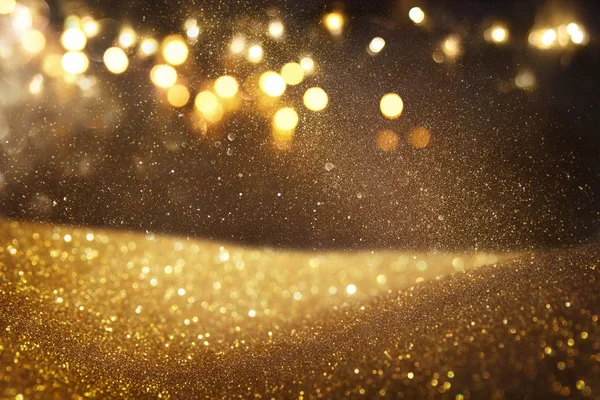 Oro e nero glitter vintage luci di sfondo. sfocato — Foto Stock