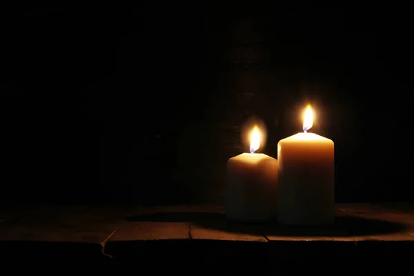 Velas ardientes sobre una vieja mesa de madera con luces bokeh —  Fotos de Stock