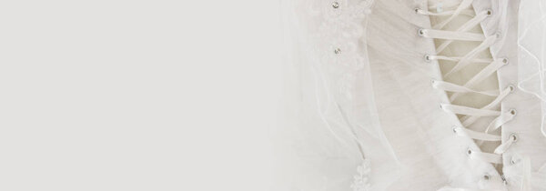 Beautiful white wedding dress and veil on chair