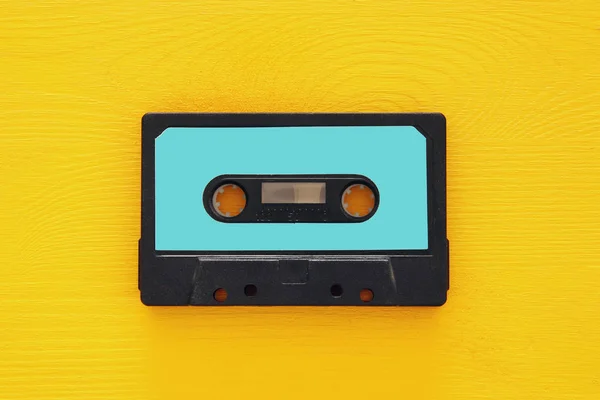 Retro cassette tape over yellow wooden table. top view. copy space — Stock Photo, Image