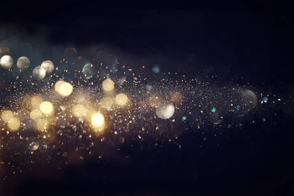Glitter vintage ışıklar arka plan. altın rengi ve siyah. defocused
