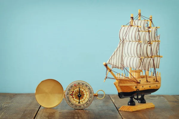 Columbus day concept with old ship over wooden background — Stock Photo, Image