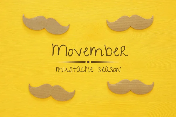 Movember cancer awareness event concept over wooden background (en inglés). Vista superior —  Fotos de Stock