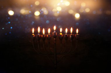 Low key abstract image of jewish holiday Hanukkah background with menorah (traditional candelabra) clipart