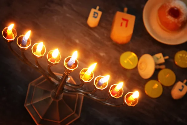 Low key image of jewish holiday Hanukkah background with menorah (traditional candelabra) and burning candles — Stock Photo, Image