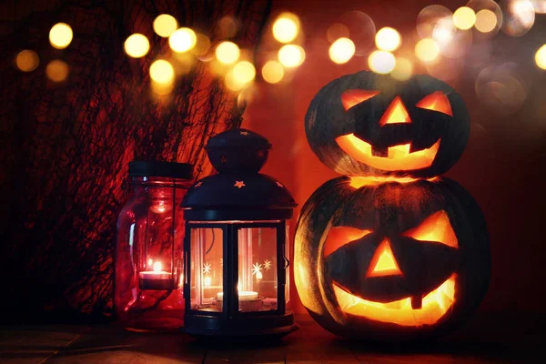 Zucca di Halloween sul tavolo di legno di fronte a sfondo scuro spettrale. Jack o lanterna — Foto Stock