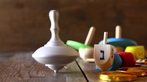 Jewish holiday Hanukkah footage with traditional wooden spinnig dreidel (spinning top). — Stock Video