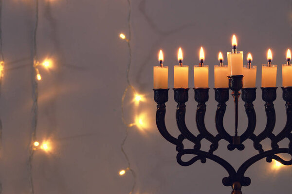 Low key image of jewish holiday Hanukkah background with menorah (traditional candelabra)