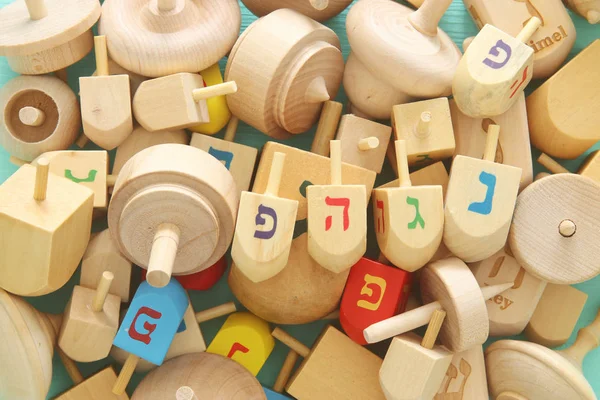 Bilden av judiska högtiden Hanukkah med trä dreidels samling (spinning överst) på bordet — Stockfoto