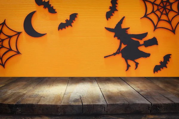 Concept van de Halloween vakantie met lege rustieke tafel over oranje achtergrond. Klaar voor de product display montage — Stockfoto