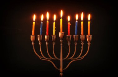 image of jewish holiday Hanukkah background with menorah (traditional candelabra) and burning candles clipart