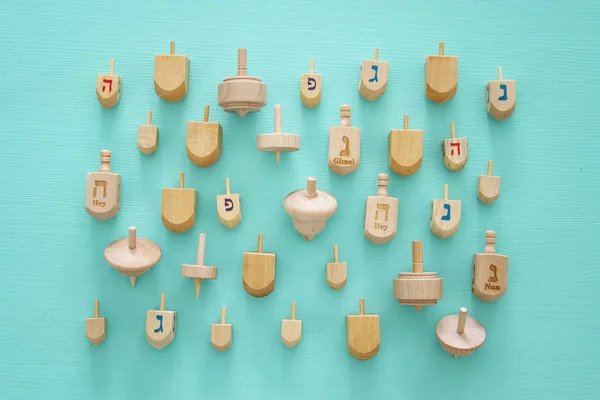 Top view Image of jewish holiday Hanukkah with wooden dreidels colection (spinning top) — Stock Photo, Image