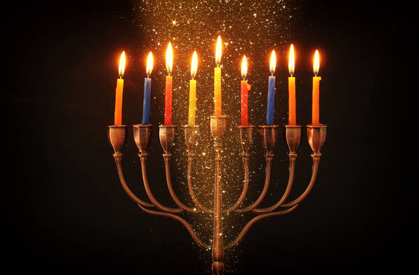 image of jewish holiday Hanukkah background with menorah (traditional candelabra) and burning candles