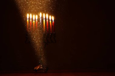 low key image of jewish holiday Hanukkah background with menorah (traditional candelabra) clipart
