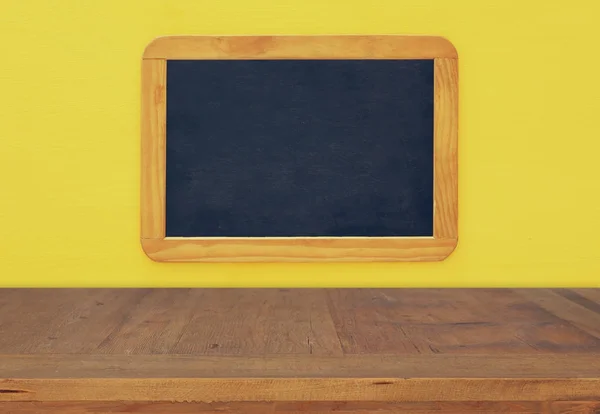 Empty vintage blackboard on wooden background — Stock Photo, Image