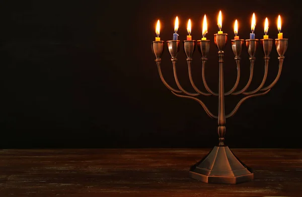 Jewish holiday Hanukkah background with menorah (traditional candelabra) and burning candles — Stock Photo, Image