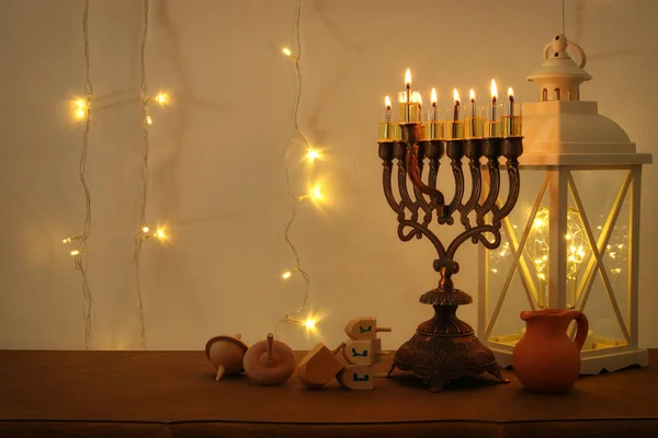 Low-Key-Bild des jüdischen Feiertags Chanukka Hintergrund mit traditionellen Spinnig Top, Menora (traditioneller Kandelaber) — Stockfoto