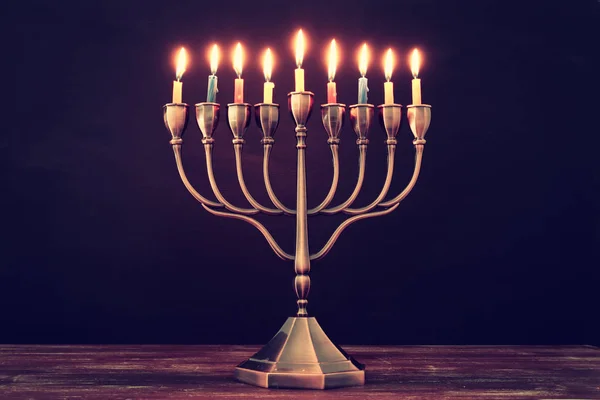 Jewish holiday Hanukkah background with menorah (traditional candelabra) and burning candles — Stock Photo, Image