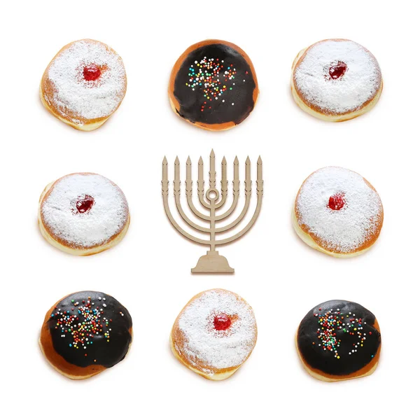 Jewish holiday Hanukkah image with traditional doughnuts isolated and menorah (traditional candelabra) on white. — Stock Photo, Image