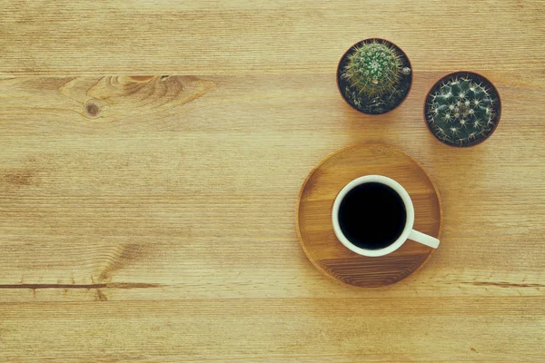 Top view image of cup of coffee on wooden table. — Stock Photo, Image