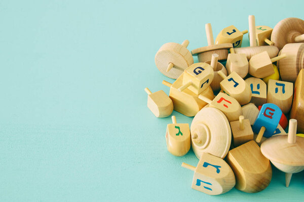 Image of jewish holiday Hanukkah with wooden dreidels colection (spinning top) on the table