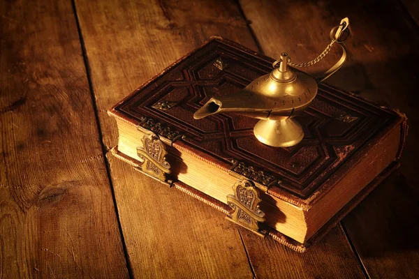 Image of magical aladdin lamp and old books. Lamp of wishes. Stock Image