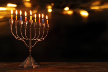 jewish holiday Hanukkah background with menorah (traditional candelabra) and burning candles clipart