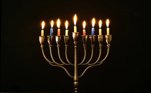 Jewish holiday Hanukkah background with menorah (traditional candelabra) and burning candles — Stock Photo, Image
