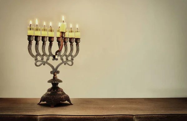 Low key image of jewish holiday Hanukkah background with menorah (traditional candelabra) and burning candles — Stock Photo, Image