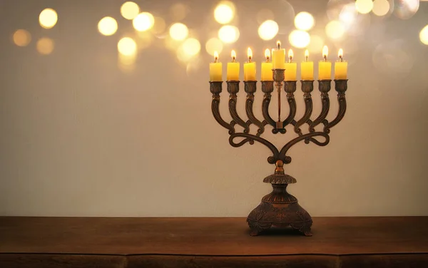 Low key image of jewish holiday Hanukkah background with menorah (traditional candelabra) and burning candles — Stock Photo, Image
