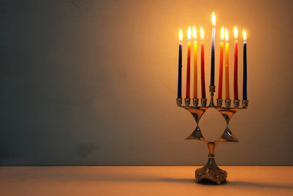image of jewish holiday Hanukkah background with menorah (traditional candelabra) and candles.