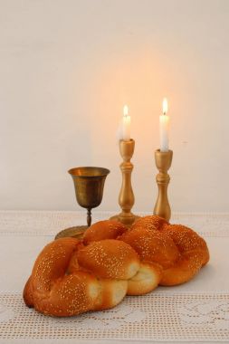 shabbat image. challah bread, shabbat wine and candles on the table. clipart