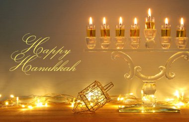 image of jewish holiday Hanukkah background with menorah (traditional candelabra) and burning candles. clipart