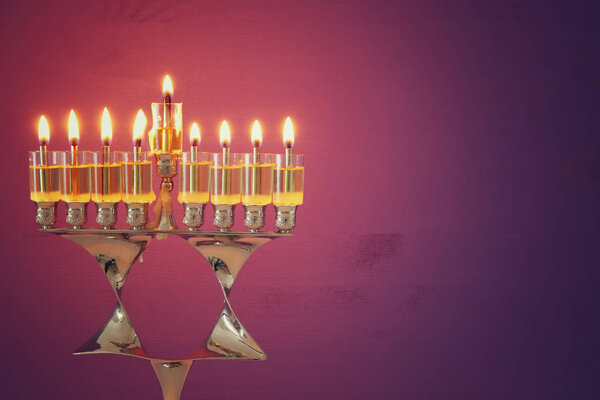 image of jewish holiday Hanukkah background with menorah (traditional candelabra) and candles.