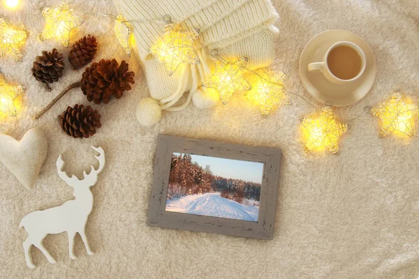 Pine cones and cup of cappuccino over cozy and fur carpet. Top view. — Stock Photo, Image