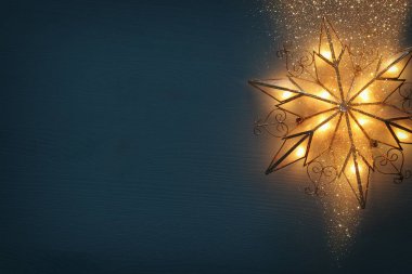 Noel yıldızı ahşap arka plan üzerinde parlayan resim.