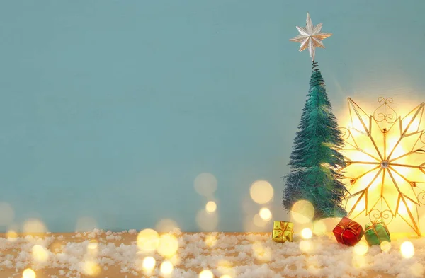 Afbeelding van kerstbomen op besneeuwde houten tafel. — Stockfoto