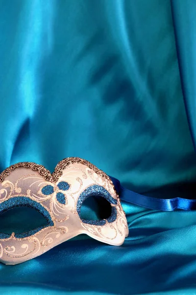 Image of elegant venetian mask over blue silk background. — Stock Photo, Image