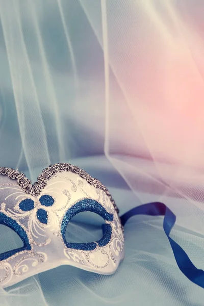 Image of delicate elegant venetian mask over blue silk and tulle fabric background. — Stock Photo, Image